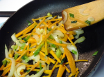 Photo of carrots, onions in pan being stir fried