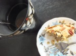 Photo of half-eaten slice with cup of tea